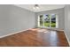 Well-lit bedroom with hardwood floors and a large window at 3561 Ventura Club Cir, Orlando, FL 32822