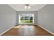 Bedroom with hardwood floors, ceiling fan, and a large window at 3561 Ventura Club Cir, Orlando, FL 32822