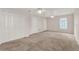 Spacious carpeted bedroom featuring a window for natural light and a closet for ample storage at 3561 Ventura Club Cir, Orlando, FL 32822