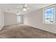 Bright bedroom with plush carpet, multiple windows, and ceiling fans for comfort at 3561 Ventura Club Cir, Orlando, FL 32822