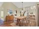 This dining room features a beautiful wooden table, chandelier and hardwood floors at 3561 Ventura Club Cir, Orlando, FL 32822
