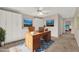 This home office offers ample storage, a large desk, and natural light for a productive workspace at 3561 Ventura Club Cir, Orlando, FL 32822