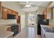 This kitchen features an oven, a ceiling fan, hardwood cabinets and a view from a window at 3561 Ventura Club Cir, Orlando, FL 32822