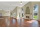 Large living room featuring wood floors, vaulted ceilings, and a cozy fireplace at 3561 Ventura Club Cir, Orlando, FL 32822