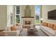 Bright, staged living room with a cozy fireplace and large windows offering a view of the outdoors at 3561 Ventura Club Cir, Orlando, FL 32822
