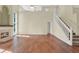Open living area with wood floors, staircase, fireplace and generous windows for natural light at 3561 Ventura Club Cir, Orlando, FL 32822