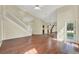 Open-concept living room with wood flooring, staircase, and ample natural light from the windows at 3561 Ventura Club Cir, Orlando, FL 32822