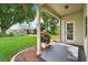 Cozy covered patio with exterior door access and view of the well-kept backyard and greenery at 3561 Ventura Club Cir, Orlando, FL 32822