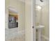 Convenient powder room with pedestal sink adjacent to kitchen at 3561 Ventura Club Cir, Orlando, FL 32822