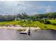 Stunning waterfront property featuring a dock, private beach, and lush landscaping at 36607 E Eldorado Lake Dr, Eustis, FL 32736