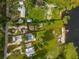 Aerial view displaying a lakefront property with a private beach, dock, and lush surroundings at 36607 E Eldorado Lake Dr, Eustis, FL 32736