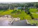 Beautiful waterfront property with a private beach, dock, and expansive lush backyard at 36607 E Eldorado Lake Dr, Eustis, FL 32736