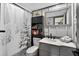 Renovated bathroom featuring decorative shower curtain, modern fixtures, and a stylish vanity at 36607 E Eldorado Lake Dr, Eustis, FL 32736