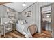 Bedroom with desk, bed, neutral wall paint and door to the bathroom at 36607 E Eldorado Lake Dr, Eustis, FL 32736