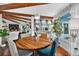 Open floor plan with modern dining area, spiral staircase, and stylish decor at 36607 E Eldorado Lake Dr, Eustis, FL 32736