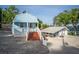 Charming blue cottage with a welcoming porch and ample parking space at 36607 E Eldorado Lake Dr, Eustis, FL 32736