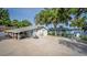 A blue house with a carport, basketball hoop and lake view at 36607 E Eldorado Lake Dr, Eustis, FL 32736