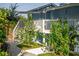 Charming blue exterior with a white staircase, balcony, and lush landscaping at 36607 E Eldorado Lake Dr, Eustis, FL 32736