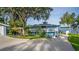 Unique two-story waterfront property with a wraparound balcony overlooking lush greenery at 36607 E Eldorado Lake Dr, Eustis, FL 32736