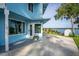 Side view of the blue house with a water view, landscaping, and a shed at 36607 E Eldorado Lake Dr, Eustis, FL 32736