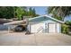 Spacious two-car garage with a carport and a basketball hoop at 36607 E Eldorado Lake Dr, Eustis, FL 32736