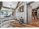 Hallway with wood floors, paintings, views to the lake, stairs and a view to the bookcase at 36607 E Eldorado Lake Dr, Eustis, FL 32736