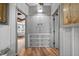 Hallway featuring wood floors, storage closet, and doorways leading to other rooms in the home at 36607 E Eldorado Lake Dr, Eustis, FL 32736