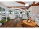 Inviting living room with vaulted wood-beam ceilings, stone accents, and views of the lake at 36607 E Eldorado Lake Dr, Eustis, FL 32736