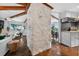 Open concept living room with exposed beams and unique stone pillar at 36607 E Eldorado Lake Dr, Eustis, FL 32736