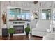 Bright living room with cozy fireplace, water view, and modern decor at 36607 E Eldorado Lake Dr, Eustis, FL 32736