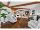 Charming living room with exposed beams, modern fireplace, and ample seating at 36607 E Eldorado Lake Dr, Eustis, FL 32736