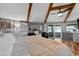 Comfortable bedroom with water views, beamed ceilings, and a slider to a patio at 36607 E Eldorado Lake Dr, Eustis, FL 32736