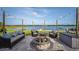 Inviting patio with comfortable seating and a cozy fire pit overlooking the serene lake at 36607 E Eldorado Lake Dr, Eustis, FL 32736