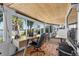 Bright sun room offering panoramic water views from many windows and wood ceiling at 36607 E Eldorado Lake Dr, Eustis, FL 32736