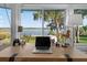 Sun room with stunning water views, desk, and decor that brings the outside in at 36607 E Eldorado Lake Dr, Eustis, FL 32736