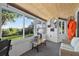 Sun room with expansive windows framing scenic views of backyard and mature trees at 36607 E Eldorado Lake Dr, Eustis, FL 32736