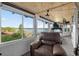 Relaxing sun room with water views, casual seating, and fitness equipment at 36607 E Eldorado Lake Dr, Eustis, FL 32736