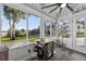 Bright sunroom featuring lots of windows with stunning views, a ceiling fan, and a slate floor at 36607 E Eldorado Lake Dr, Eustis, FL 32736