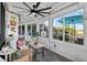 A sunroom with tile flooring, large windows with views, and a ceiling fan at 36607 E Eldorado Lake Dr, Eustis, FL 32736