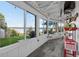 A sunroom with a lake view, tile floors, and large sliding windows at 36607 E Eldorado Lake Dr, Eustis, FL 32736