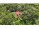 Aerial view of a lovely home nestled in a serene, tree-filled landscape offering privacy at 4200 Joslyn Ln, Lady Lake, FL 32159