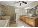 Spacious bathroom featuring double sinks, a soaking tub, and a separate glass shower at 4200 Joslyn Ln, Lady Lake, FL 32159
