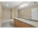 Bathroom features a double sink vanity, shower over tub, and tile flooring at 4200 Joslyn Ln, Lady Lake, FL 32159