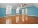 Bright bedroom boasting beautiful hardwood floors, a ceiling fan, and an ensuite bathroom at 4200 Joslyn Ln, Lady Lake, FL 32159