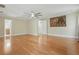 Large bedroom with hardwood floors, neutral paint, and a ceiling fan at 4200 Joslyn Ln, Lady Lake, FL 32159