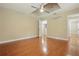 Bedroom with hardwood floors, ceiling fan, and door leading to another room at 4200 Joslyn Ln, Lady Lake, FL 32159