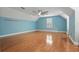Expansive bedroom featuring hardwood floors, natural light, and a ceiling fan at 4200 Joslyn Ln, Lady Lake, FL 32159