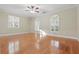Bedroom with hardwood floors, ceiling fan, and three windows with shutters at 4200 Joslyn Ln, Lady Lake, FL 32159
