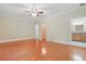 Bedroom with hardwood floors, ceiling fan, and an ensuite bathroom visible at 4200 Joslyn Ln, Lady Lake, FL 32159