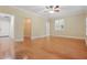 Bedroom with hardwood floors, ceiling fan, and walk-in closet accessible at 4200 Joslyn Ln, Lady Lake, FL 32159